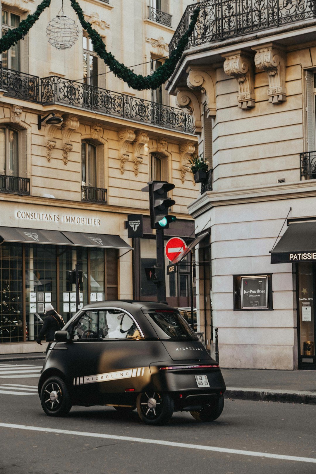 Small electric city car parked on a modern urban street