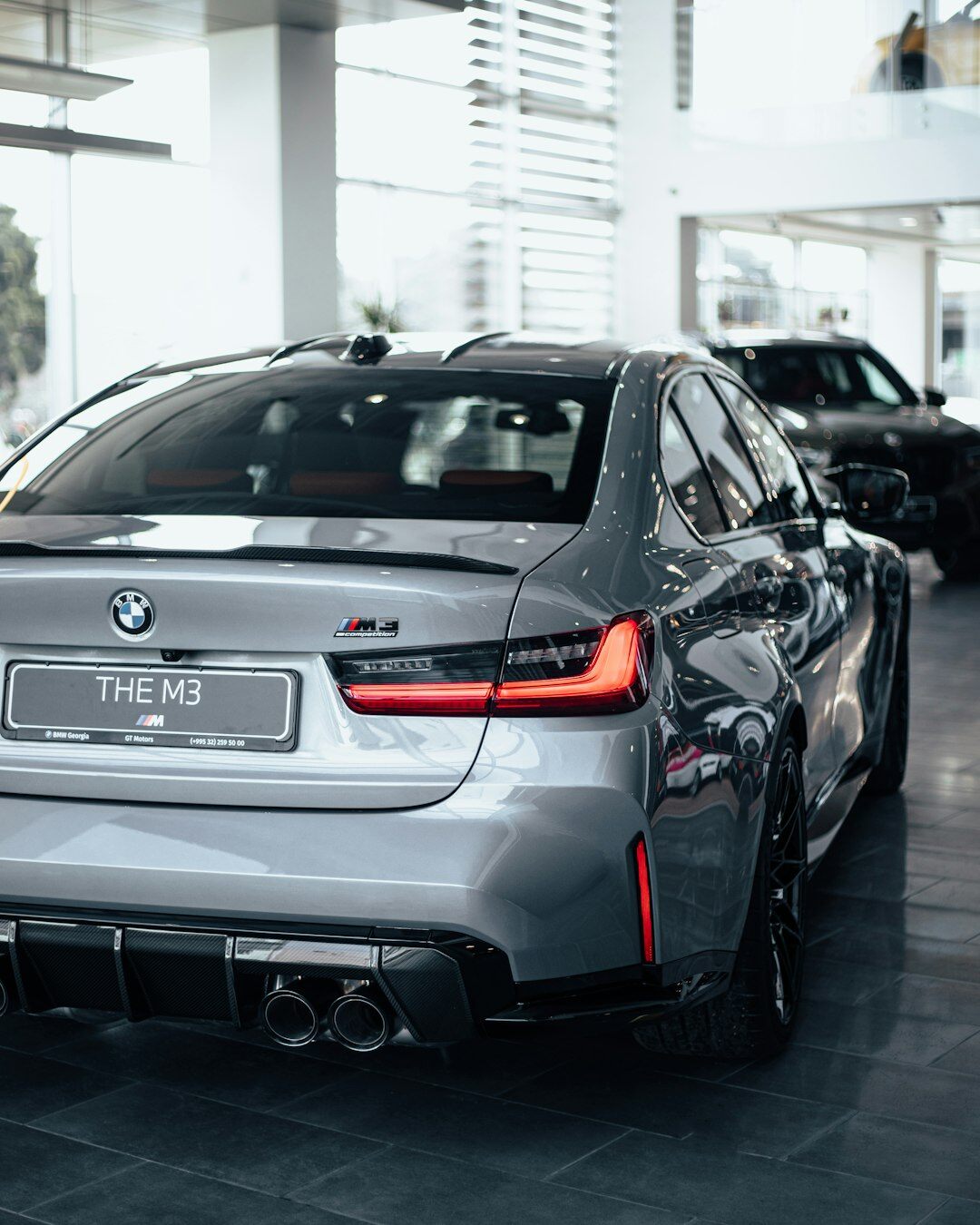 Modern car showroom with several premium vehicles on display