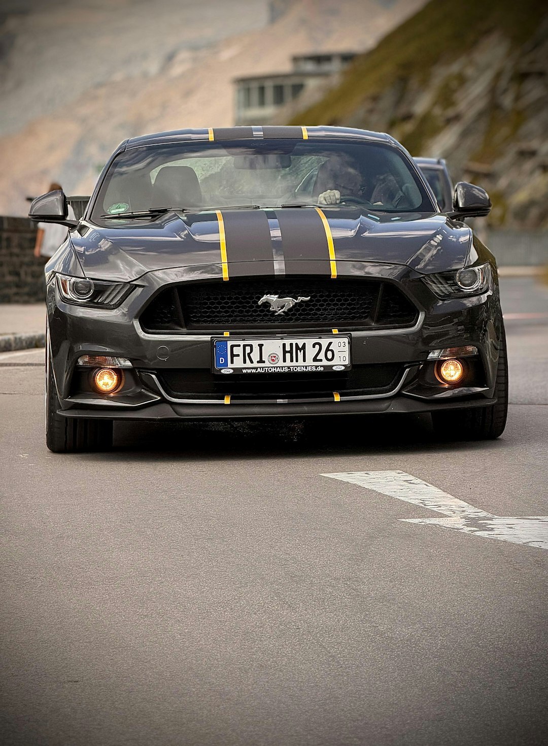 luxury car driving on mountain road