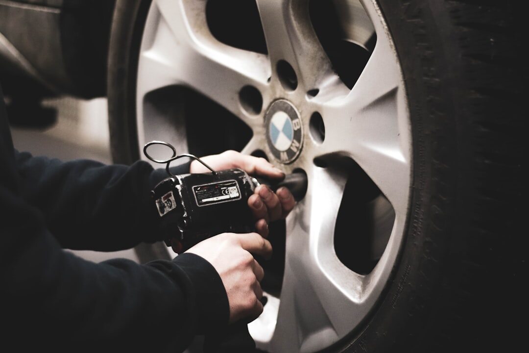 person checking tire pressure